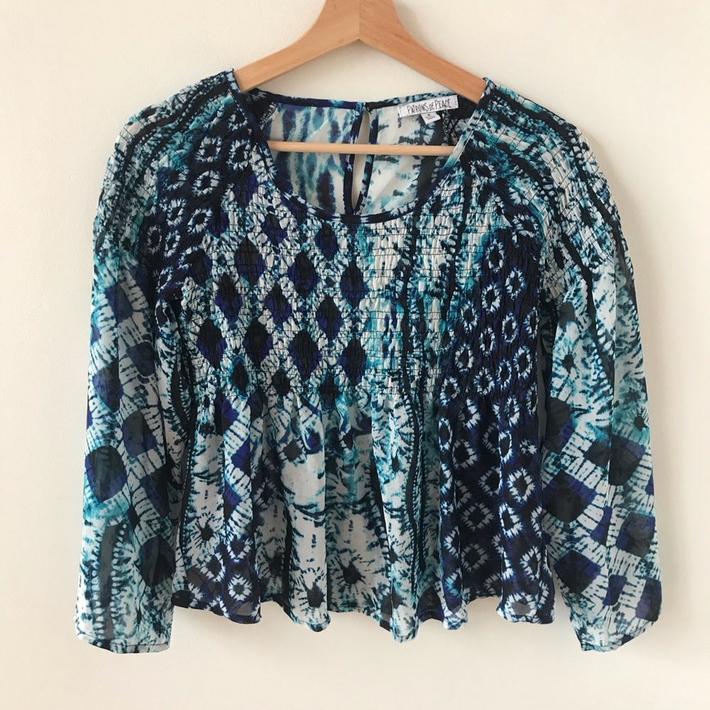 Patrons of Peace blue, white, and teal pattern top